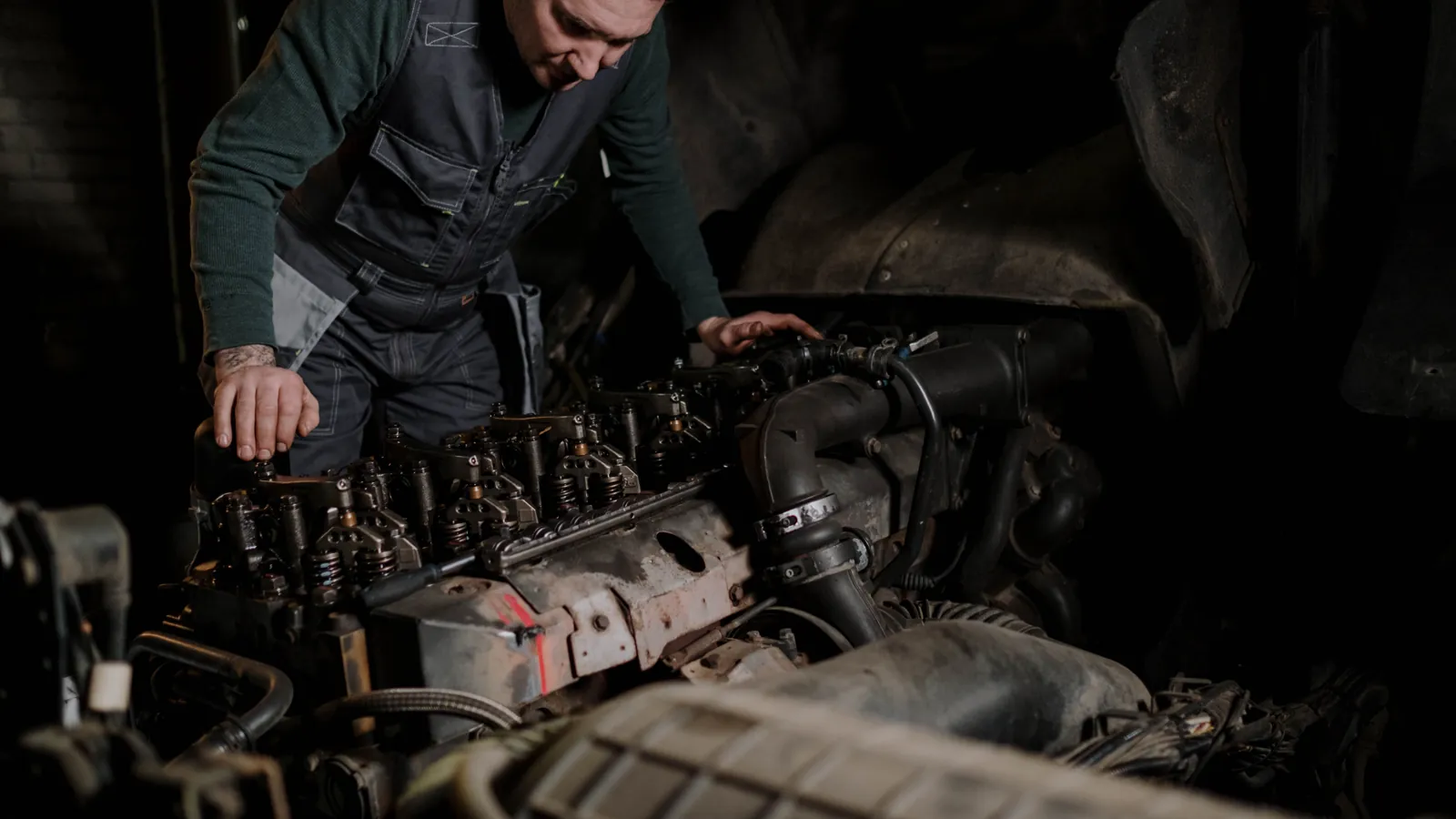 A diesel technician repairing a truck engine