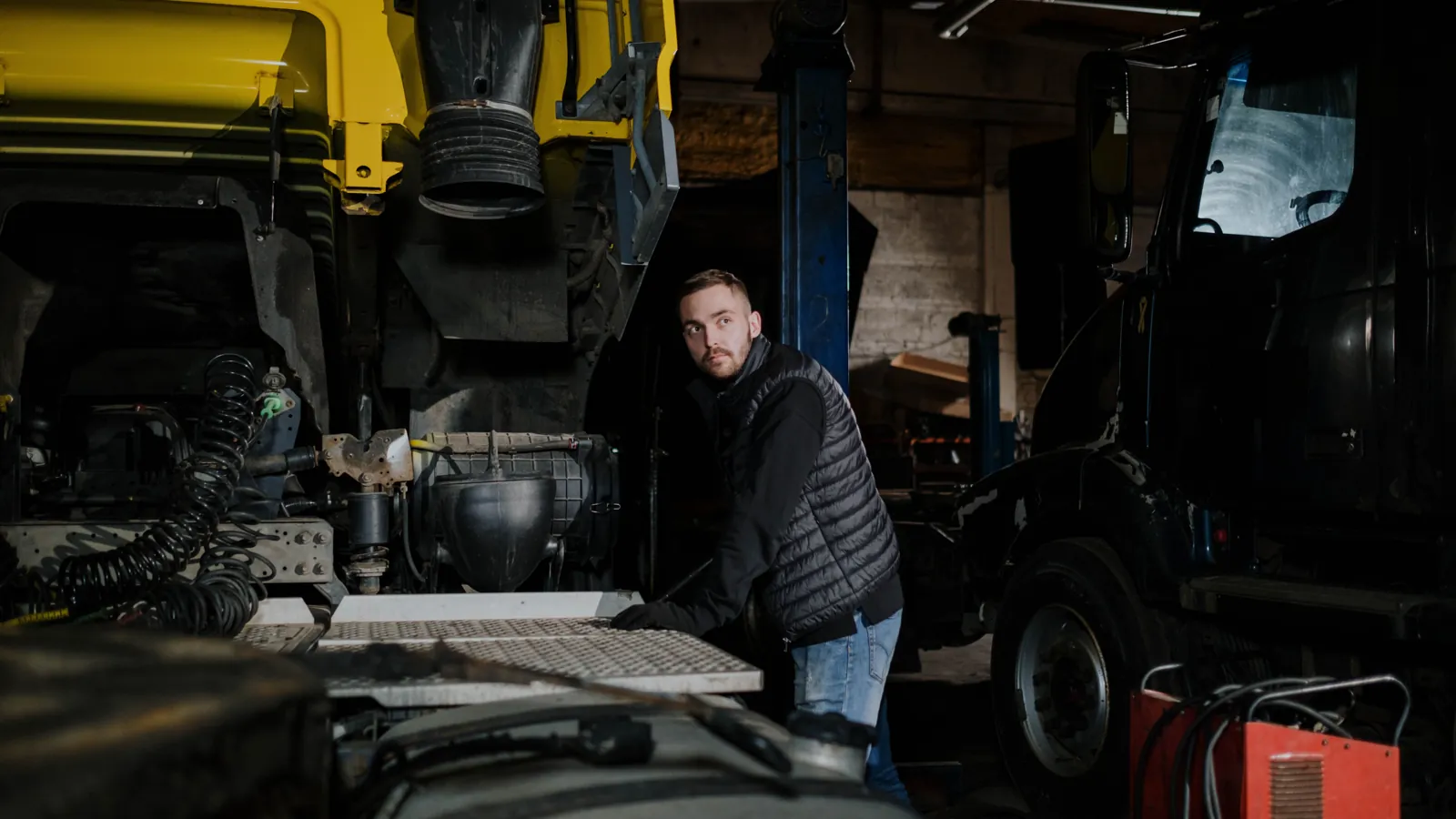 A mobile diesel mechanic working on a truck